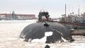 Russian Oscar II submarine with Kirov class battlecruiser in the background.jpg